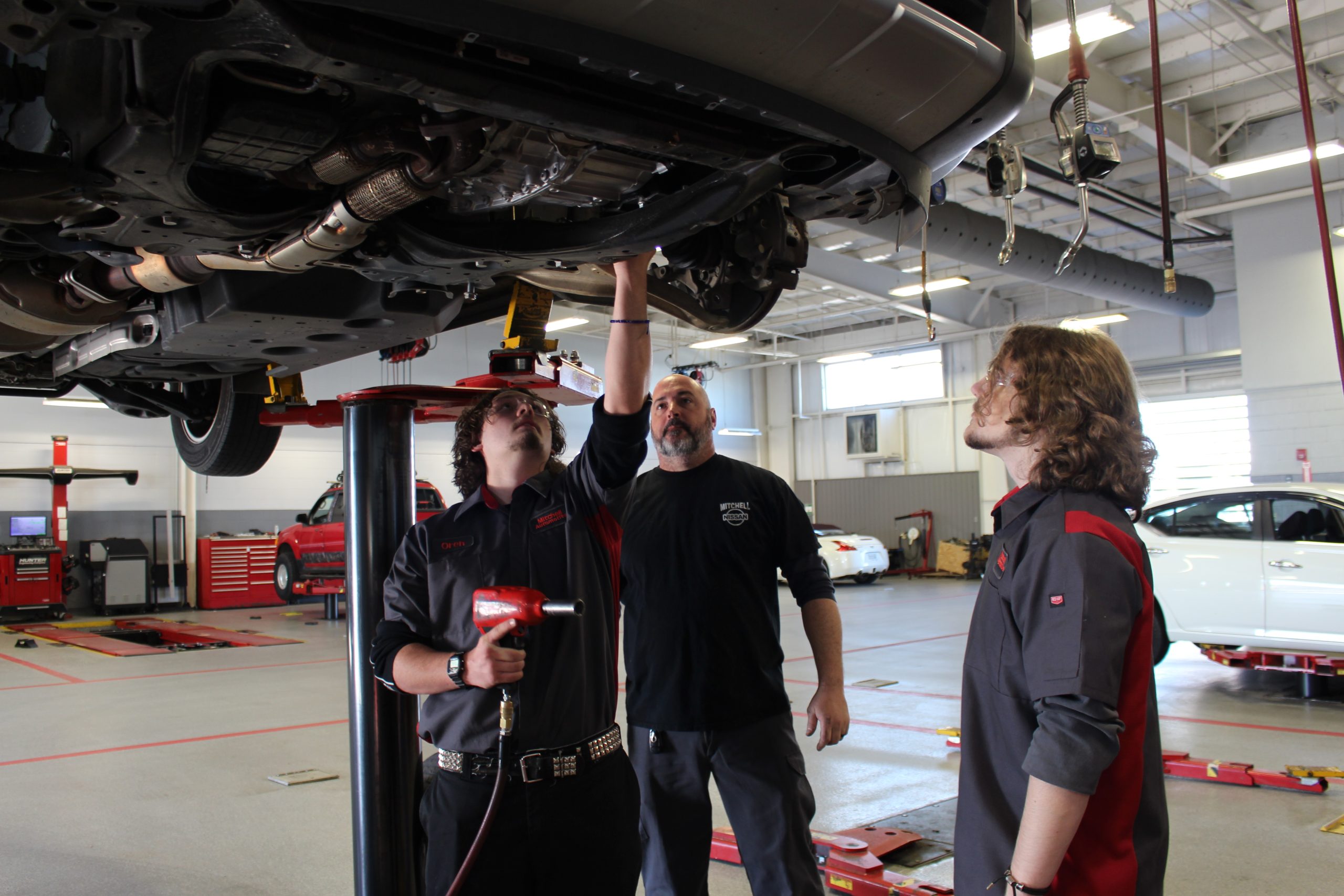 A Geneva County Automotive Tech student performs a basic hands-on task in the Mitchell Nissan service bay.
