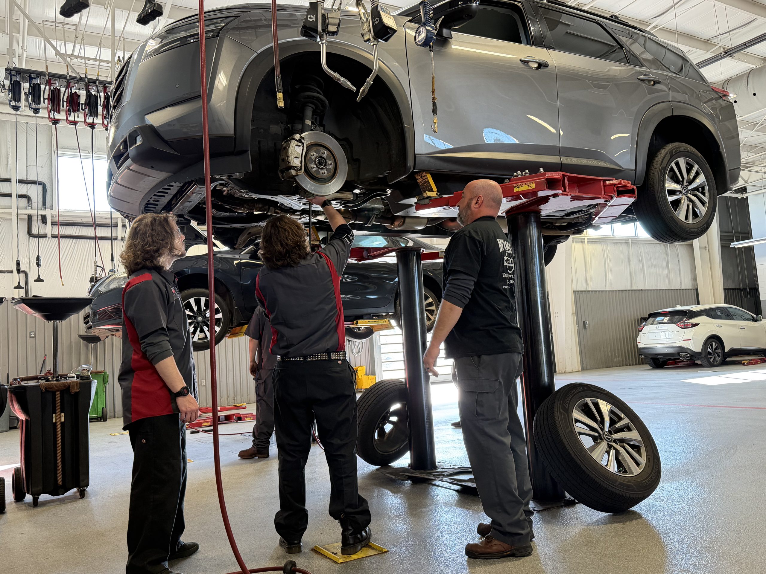 A Geneva County Automotive Tech student performs a basic hands-on task in the Mitchell Nissan service bay.