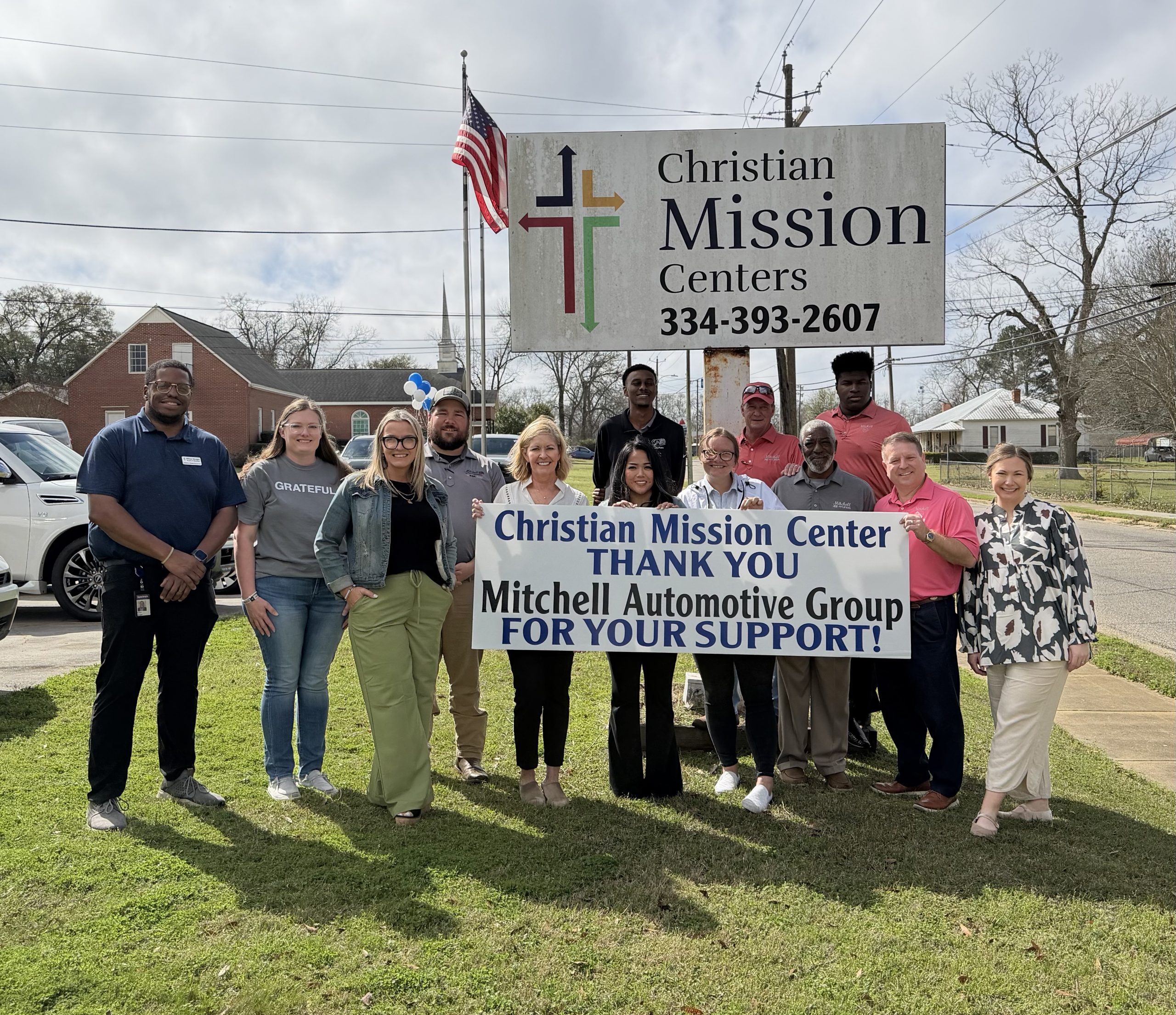 Group photo of Mitchell Automotive employees delivering Stock the Pantry donations to Christian Mission